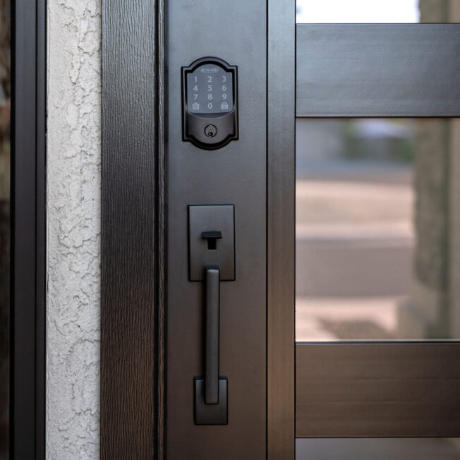 Closeup of a Schlage® Encode Plus™ Smart WiFi Entry Door Deadbolt in Black with Camelot Trim