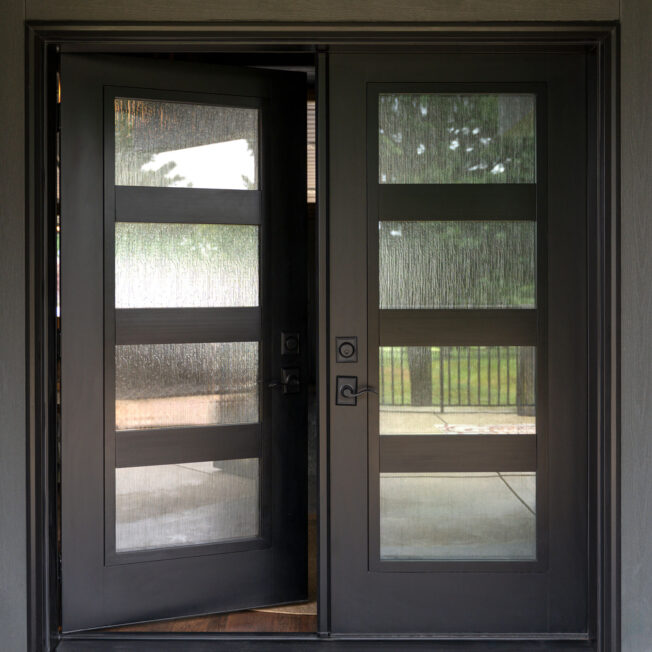 Closeup exterior view of ProVia® Signet® Smooth 460-T5-4L fiberglass French Doors in Coal Black with Waterfall Privacy Glass