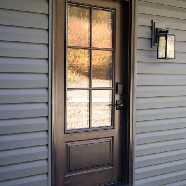Exterior view of a ProVia® Signet® Cherry 440-1P entry door in Coffee Bean with cottage-style simulated divided lites