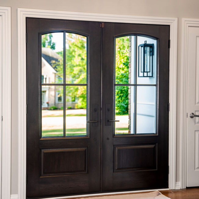 Interior view of a entryway featuring ProVia® Signet® Cherry 449 French Doors in Hazelnut stain with cottage-style simulated divided lites