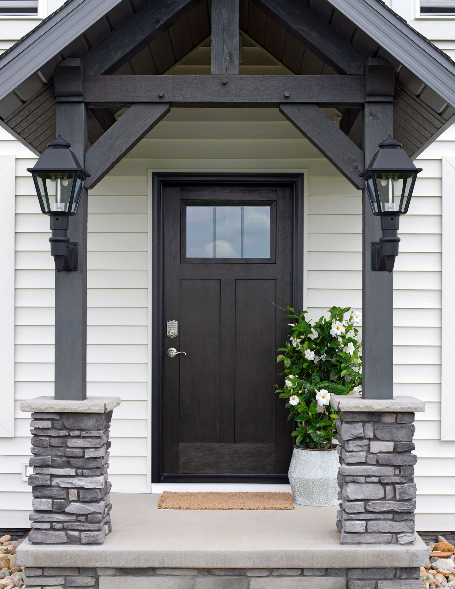 Exterior view of a ProVia® Signet® Fir 420 entry door in Black paint with Internal Grids
