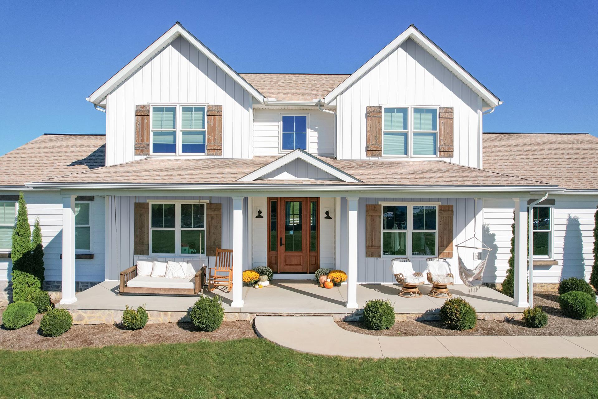 Image of a 2-story home featuring ProVia® CedarMAX®12-Inch Board and Batten in White