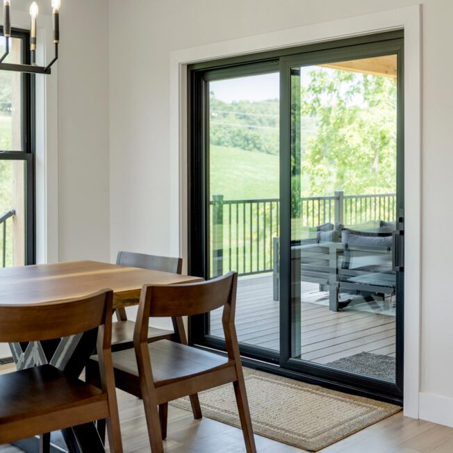 Interior view from a dining room of a ProVia® Endure™ 2-Lite Patio Door in Textured Matte Coal Black