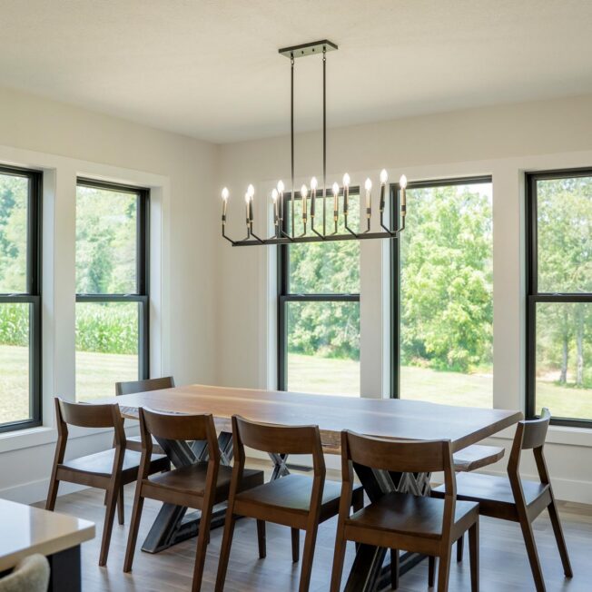 Interior view of a dining room with ProVia® Endure™ Double Hung and Picture Windows in Textured Matte Coal Black
