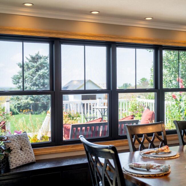 Interior view of ProVia® Endure™ Double Hung Windows in Textured Matte Coal Black from a dining room looking out