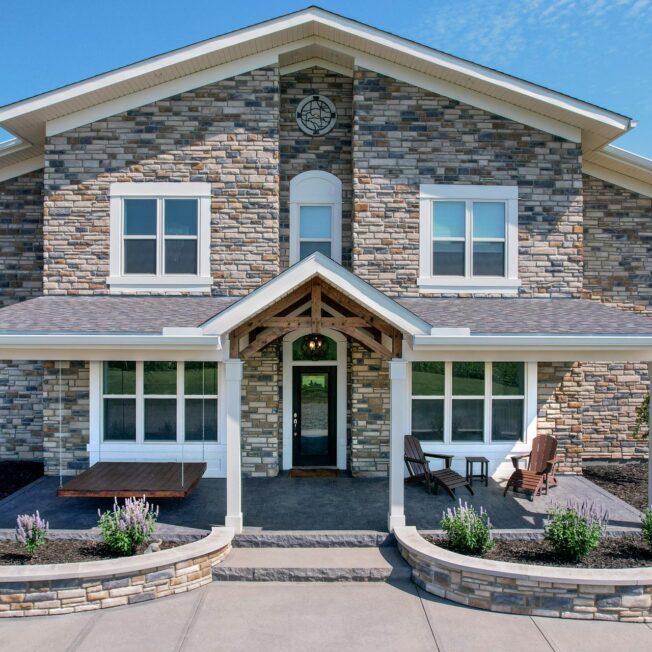 Exterior view of a home with ProVia® Dry Stack Lakepointe Manufactured Stone