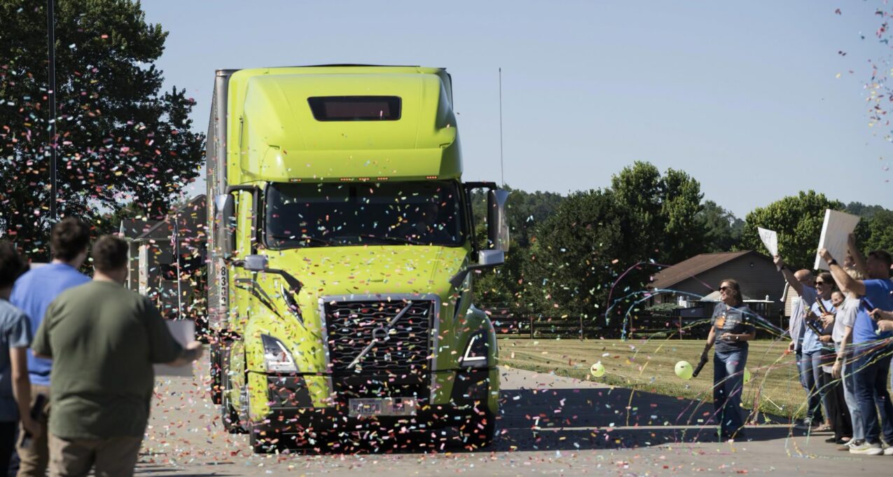 Employees and family of a ProVia® truck driver celebrate his Million Mile Club induction with confetti as his truck pulls in to a ProVia facility.