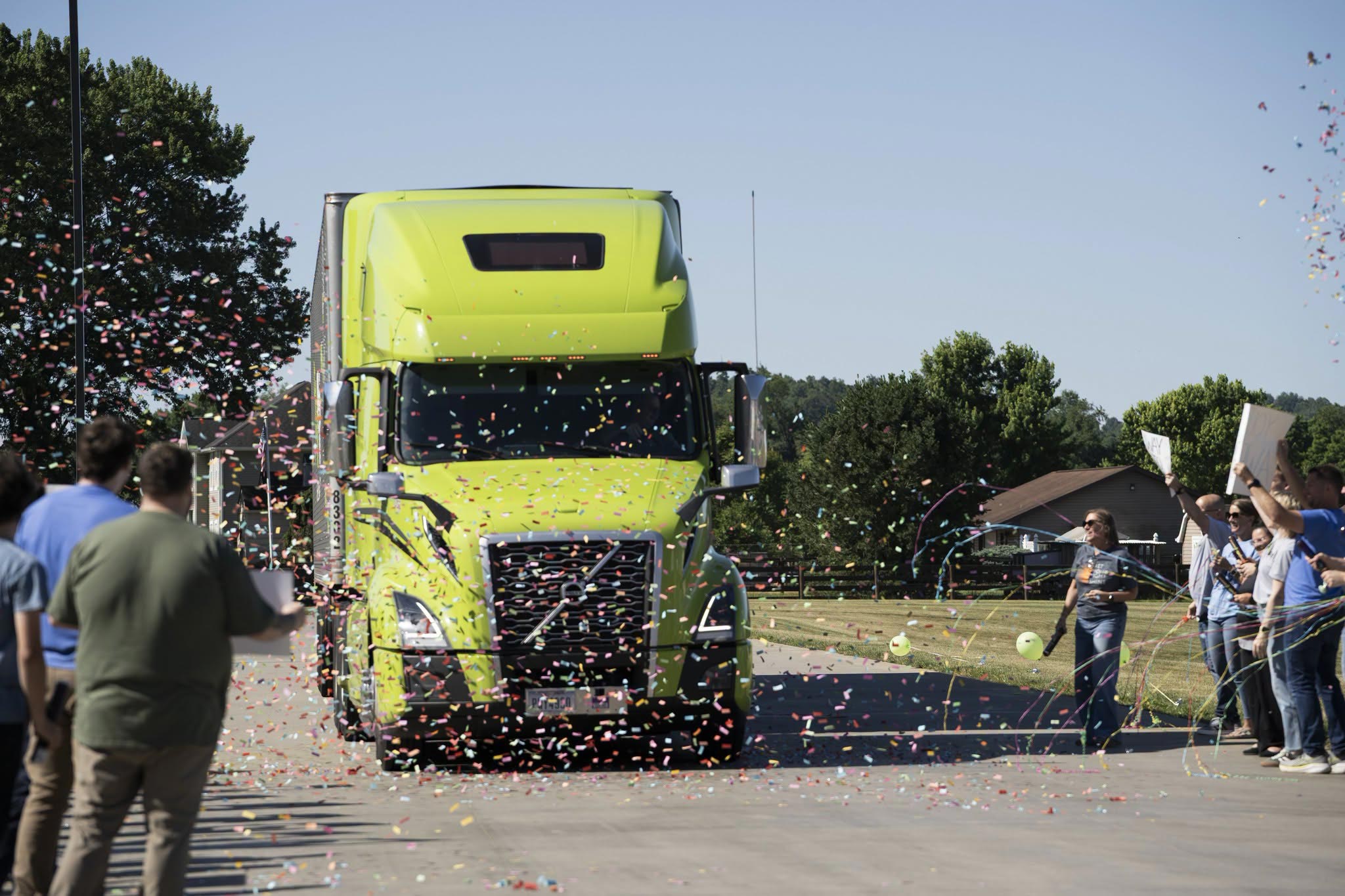 Employees and family of a ProVia® truck driver celebrate his Million Mile Club induction with confetti as his truck pulls in to a ProVia facility.