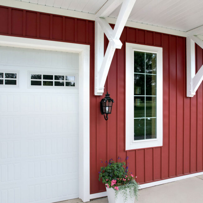 Exterior view of ProVia® EcoLite­™ Picture Windows in White on a red building