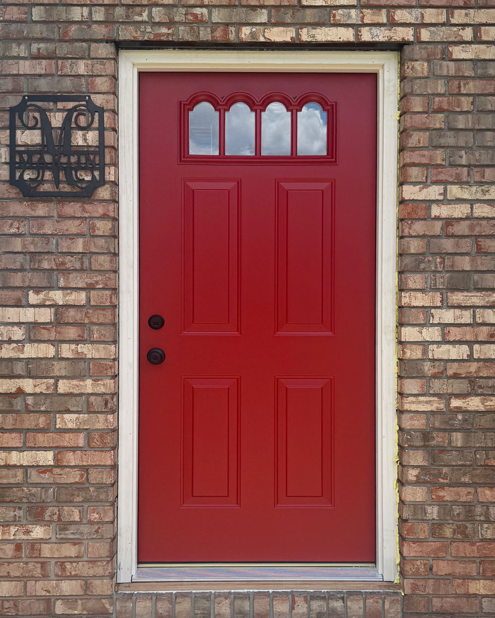 Exterior close-up view of a ProVia® Legacy™ Smooth 410-4P Entry Door in Vallis Red