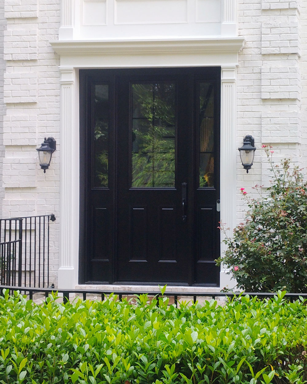 Exterior view of a ProVia® Legacy™ Smooth 430-2P Entry Door and 130 Sidelites in Coal Black with Internal Cottage Grids
