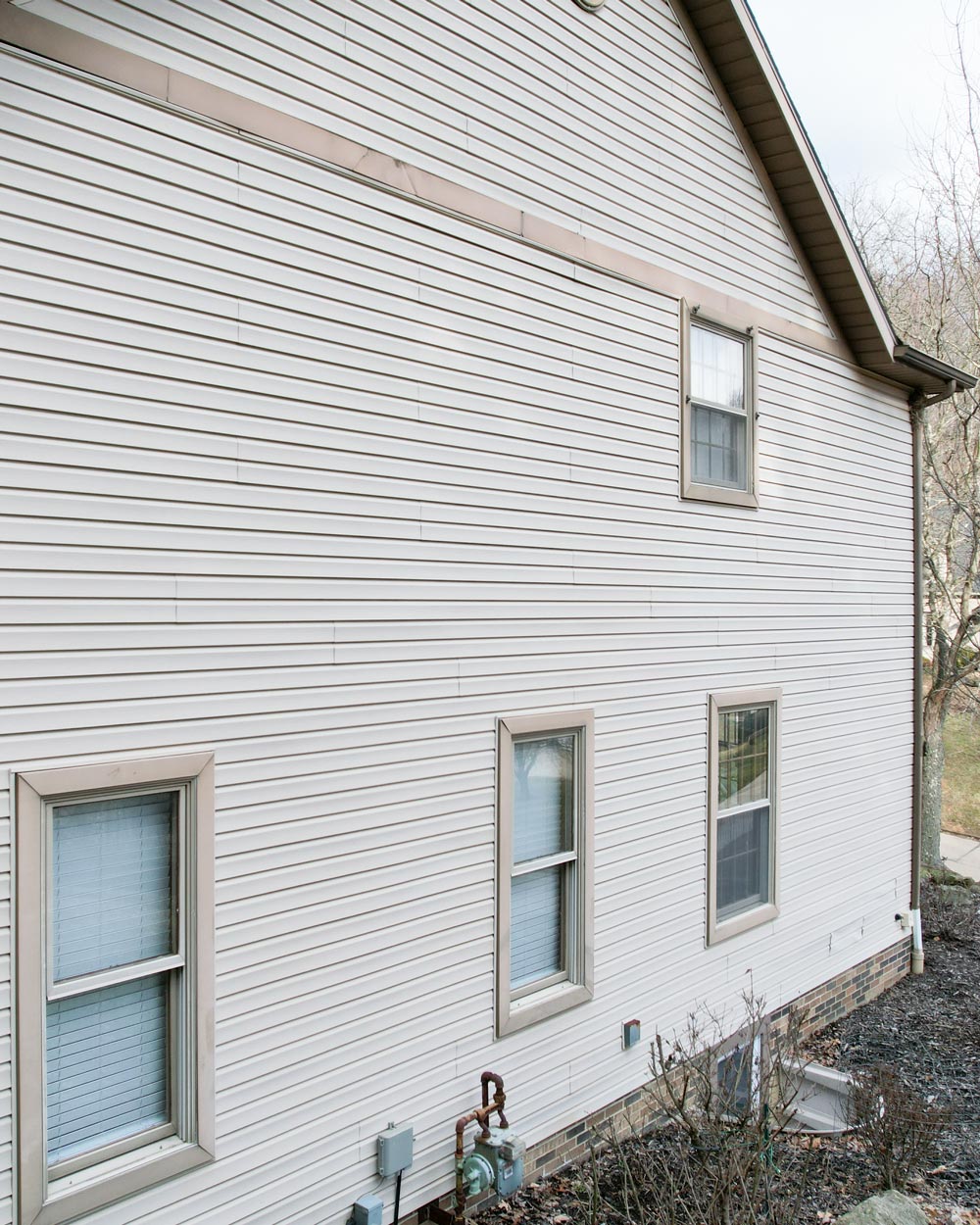 Exterior view of the side of a home before a home exterior remodel