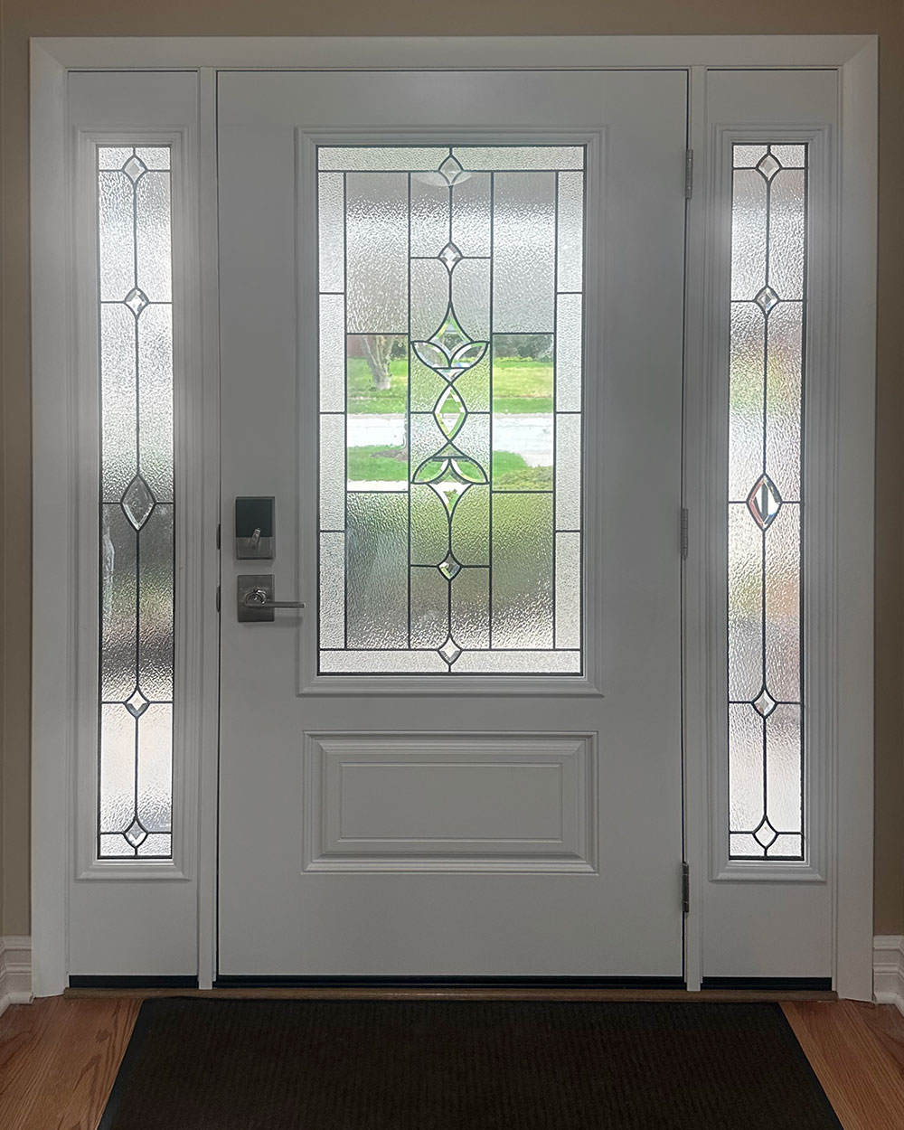 Interior view of a ProVia® Legacy™ 440-1P Entry Door and 160 Sidelites in Snow Mist with Esmond Decorative Glass
