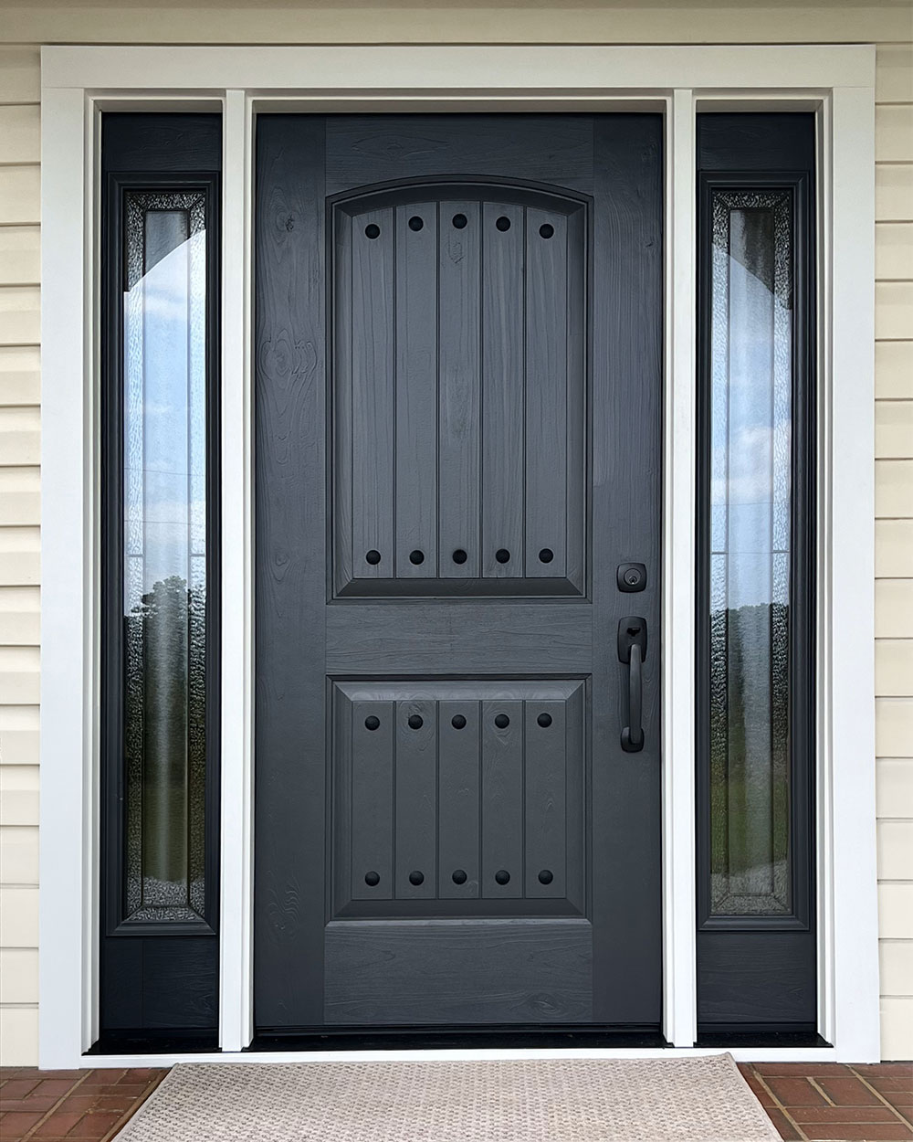 A ProVia® Signet® Knotty Alder 002CP-437 Entry Door with Clavos and 160 Sidelites in Nightfall with Aria Decorative Glass
