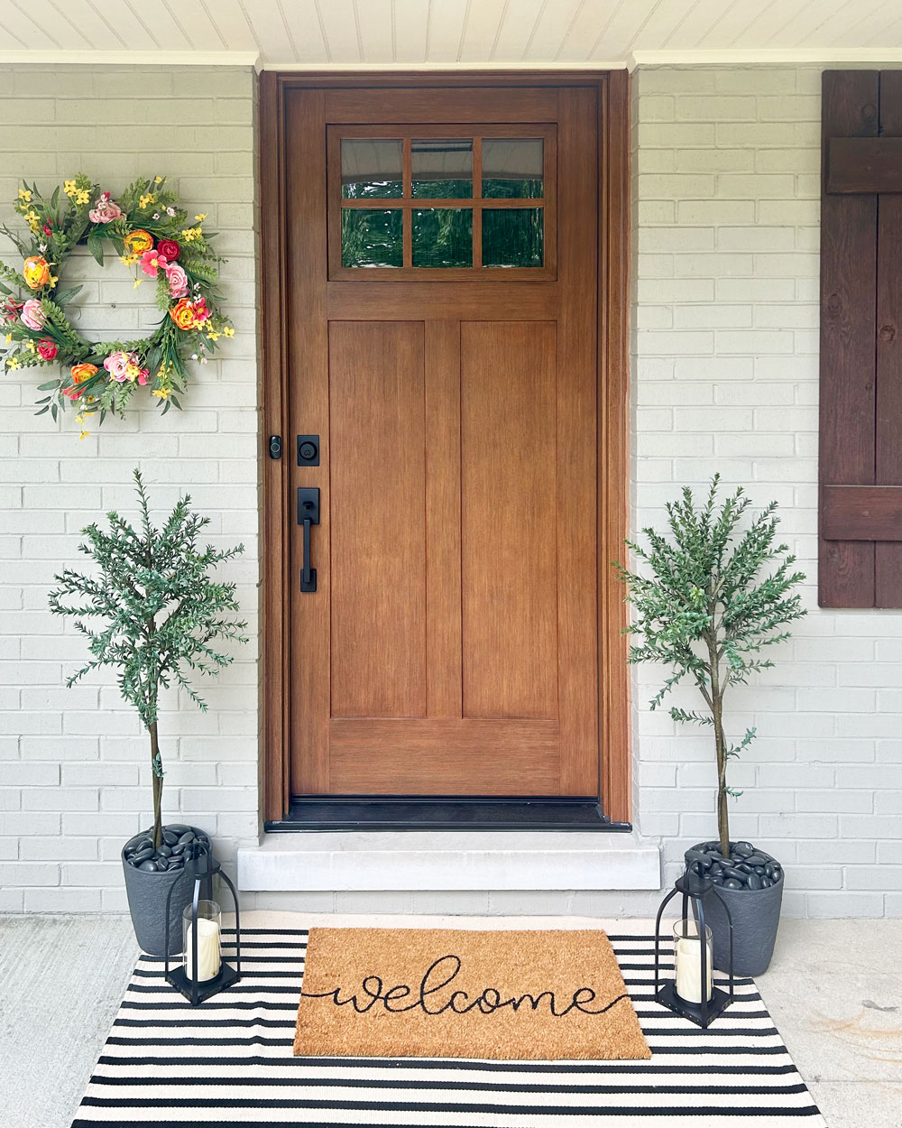 Exterior view of a ProVia® Signet® Fir 420 with entry door with Simulated Divided Lites in Caramel stain.